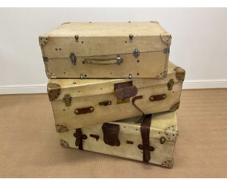 An early 20th century vellum travel trunk with leather and studded exterior, height 36cm, width 91cm, depth 52cm, with an ear