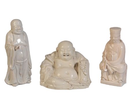 A CHINESE BLANC DE CHINE RECLINING BUDAI 19th century or later, clutching prayer beads in one hand, 15cm high; together with 