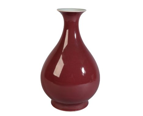 A CHINESE SANG DE BOEUF VASEbearing a six character Qianlong seal mark, of pear shape with flared foot, 30cm high