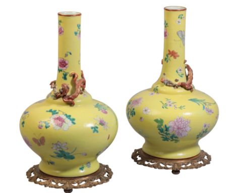 A PAIR OF CHINESE YELLOW GROUND FAMILLE ROSE INCISED BOTTLE VASESwith Qianlong seal to the base, possibly 19th century, with 