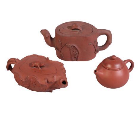 THREE CHINESE YIXING TEAPOTS AND COVERS 19th century, one with frog finial on lotus shaped body decorated with applied insect