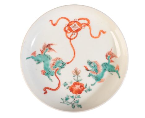 A JAPANESE KAKIEMON DISH c.1700-1720, decorated with two lion dogs playing with a brocaded ball, 13cm diameterProvenance: R &
