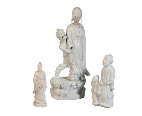 TWO CHINESE BLANC DE CHINE FIGURAL GROUPS 19th century or later, one of a whiskered Wenchang supported by Kui Xing, another o
