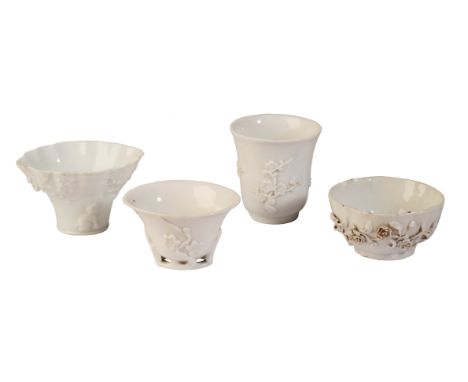 THREE BLANC DE CHINE LIBATION CUPS 19th century, all decorated with blossoming prunus, the largest 8cm high; together with a 