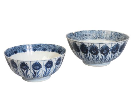 TWO CHINESE BLUE AND WHITE BOWLS Kangxi, one bearing a blue flower mark to the base, both decorated with lotus flowers in pan