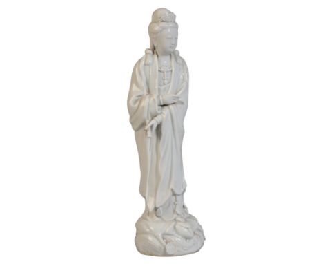 A CHINESE BLANC DE CHINE GUANYIN 19th century or later, stood on lotus base holding scroll in one hand and with tiara, 31cm h