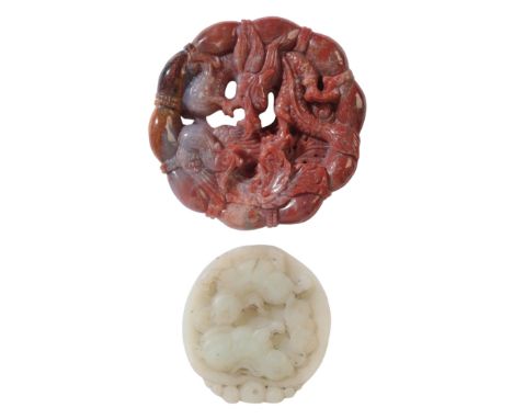 A CHINESE CARVED AGATE ROUNDELdecorated in relief with a phoenix and a dragon, 6.5cm wide; together with a jade pendant, reli