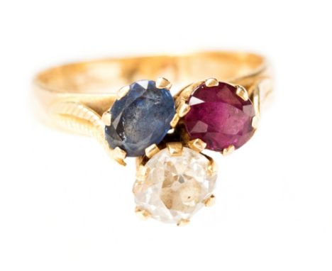 A ruby, sapphire and diamond trefoil ring, claw set old cut diamonds of approximately 0.75ct in cluster with oval cut ruby an