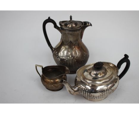 A Victorian silver three piece tea service, comprising tea pot, milk jug and hot water jug, Elkington and Company, Birmingham