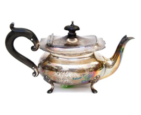 A George V silver bachelor's teapot on four feet with stained and turned hardwood handle and finial, maker's mark for Walker 