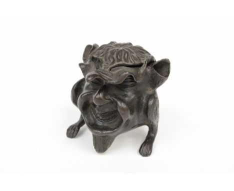 A novelty bronze inkstand, early 20th century, modelled as a grinning satyr, hinged cover, ear pen rests, height 7cm