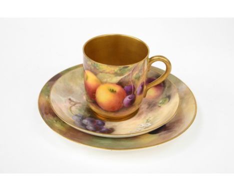 A Royal Worcester fruit painted cabinet coffee can trio, early 20th Century, comprising coffee can with gilt interior, saucer