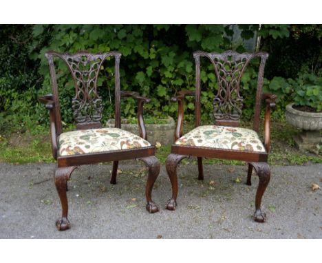 A pair of late Victorian mahogany open armchairs, in the manner of Thomas Chippendale, each with a shaped crest rail over a c