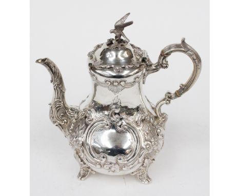 A Victorian silver floral embossed coffee pot with C scroll handle and cast bird of prey finial, supported on four feet, Elki