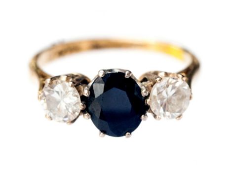 A sapphire and diamond ring, dome set central oval sapphire flanked by two diamonds, each of approximately 0.4cts, 18ct shank