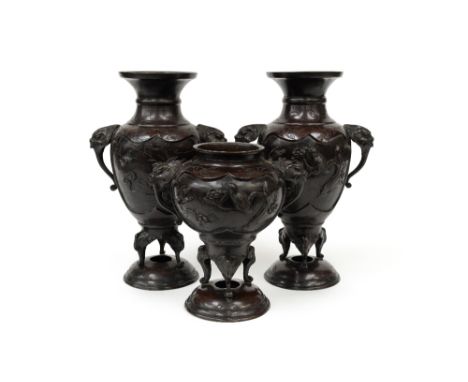 A garniture of Japanese bronze vases/koro, Meiji period (1868-1912), each with dragon mask handles and cartouche panels of ex