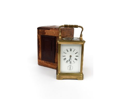 A French brass repeating alarm carriage clock, c.1900, corniche case with visible escapement, enamel Roman dial, gong strikin