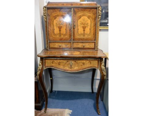 A 19th century Bonheur de Jour, the whole marquetry inlaid and ormolu mounted, the upper section with a sloped edge top over 
