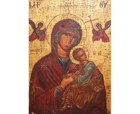 A Greek icon, 19th century, Constantinople School, gilt and polychrome on a wooden panel, depicting Madonna and child flanked