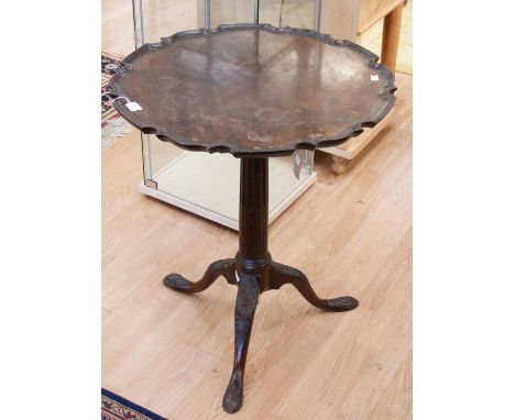 A George III mahogany tilt-top tripod table, circa 1770, the shaped top with a pie crust edge, supported on a bird-cage mecha