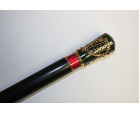 A Russian walking cane, yellow metal, guilloche enamel and nephrite pommel, (struck marks), ebonised shaft, brass ferule, len