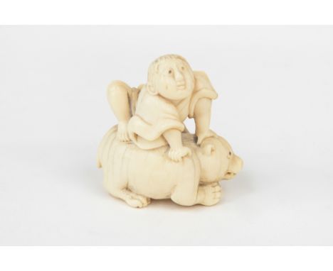 A Japanese ivory netsuke, late 18th/early 19th century, carved as a young Senin clambering onto the back of a crouching bear,