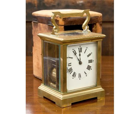 A brass carriage clock, late 19th century, corniche case, visible escapement, enamel Roman dial, gong striking mechanism, hei