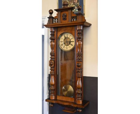 A late 19th century Austrian walnut cased wall clock,&nbsp;with architectural case, break arch pediment and column sides. An 