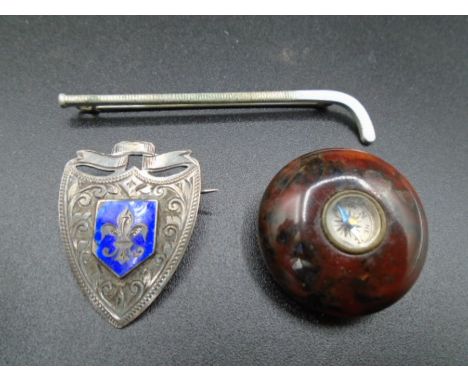 A Silver hallmarked Shield brooch (Birmingham 1919) with inscription on back 'B.N.C.C.L 1919', Metal hockey stick brooch and 