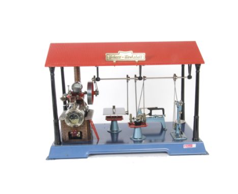 A Wilesco Live Steam D141 Workshop, with tablet-fired single-cylinder engine, set into a covered workshop with lineshaft driv