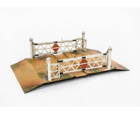 An Early Märklin O Gauge Level Crossing, approx 7" long and in the English style with lattice gates, the base hand-enamelled 