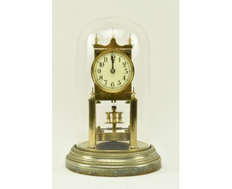 Gustav Becker, Freiburg - A German early 20th century Medaille D'Or brass anniversary mantle clock in glass dome. The clock a