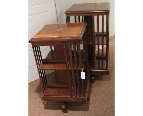 Revolving Bookcase. An Edwardian mahogany revolving bookcase, the inlaid top above shelves on a cruciform stand with ceramic 