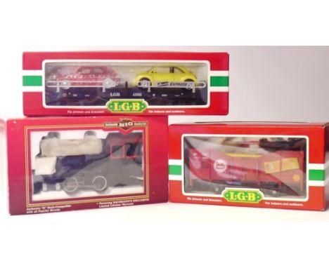 A Bachmann 'Big Hauler' Locomotive and two LGB Freight Cars, the locomotive a 'Porter' 0-4-0T in unlettered black with red tr