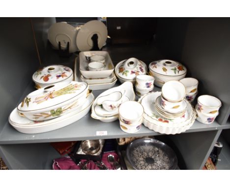 A group of Royal Worcester Evesham pattern dinner wares, decorated with gilt edges, fruit and foliage on a ice white ground, 