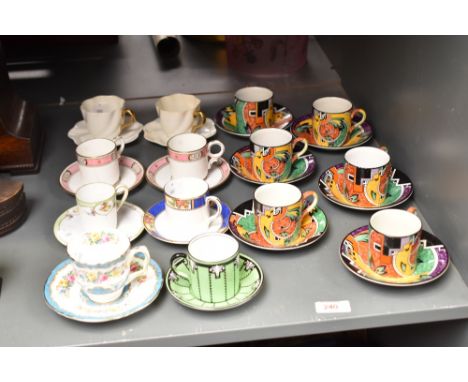 A set of 6 early 20th century Royal Winton Grimwade Jazz pattern tea cups and saucers, sold together with a pair of Coalport 