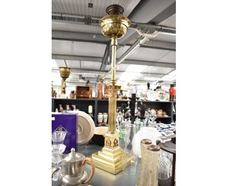 A early 20th century telescopic brass Corinthian column oil lamp, supported on a three step base, decorated with floral and s