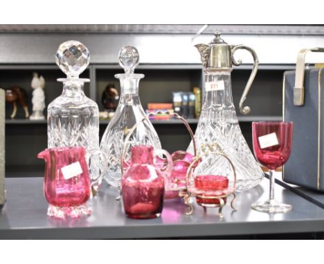 A vintage cut crystal claret jug having silver plated Bacchus spout and lid with scroll handle, h29cm, sold together with two