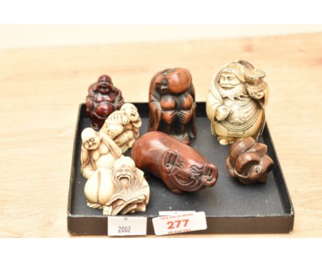 A Japanese carved wooden snake Netsuke Ojime ball, signed to base, h3.5cm, sold together with a Netsuke pig and a risen Buddh