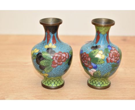 A pair of small 20th century Chinese cloisonné enamel vases, decorated with blossoms and repeating designs 10cm