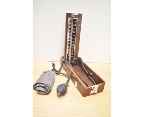 A vintage wooden cased blood pressure reader, by Accoson