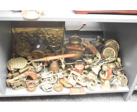 A large group of brass and copper ware, to include a door knocker, bell, candlesticks, tea pot ect