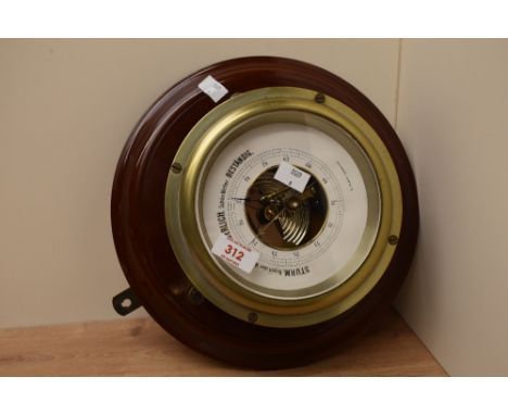 A German mahogany mounted brass barometer by C Plath, Hamburg, the circular dial with scale and exposed mechanism 28cm diamet