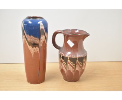 An earthenware brown pitcher decorated with wavy drip glaze patterns, h19cm, sold together with a similar style vase ( 2 )