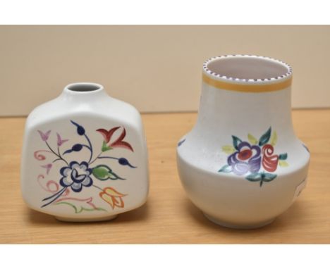 A vintage Poole pottery vase, decorated with floral patterns on a white ground, h13cm, sold together with another Poole vase,