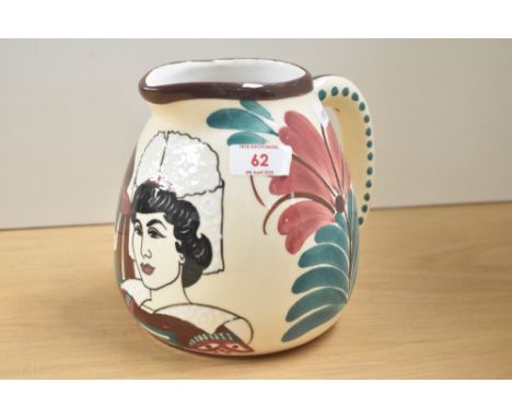 A ceramic jug decorated with male and female figures and foliage on a cream glaze ground, h15cm