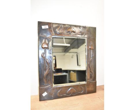 A late 19th/early 20th century Art Nouveau design copper framed mirror, with bevelled plate, the frame embossed with stylised
