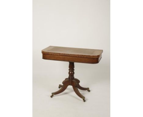 A GEORGE IV MAHOGANY CARD TABLE, the fold-over top with rounded corners enclosing a baize-lined playing surface, on a turned 