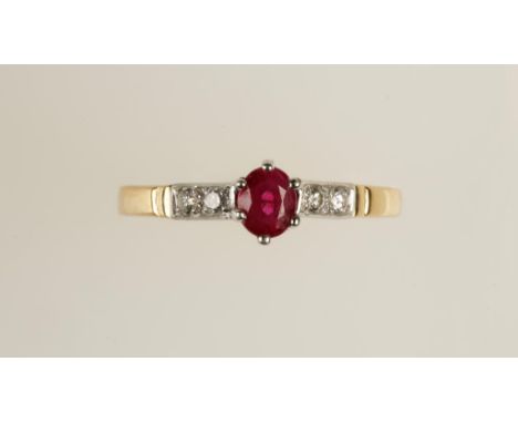 A RUBY AND DIAMOND DRESS RING, the oval-cut ruby flanked to either side by two pave-set diamonds, on an 18ct yellow gold shan