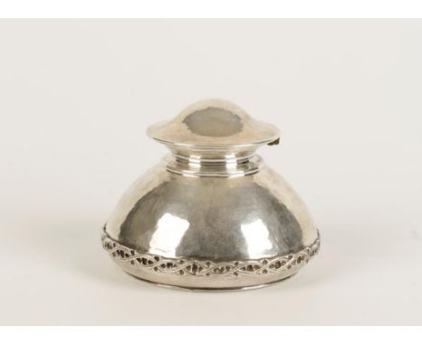 OMAR RAMSDEN: AN ARTS AND CRAFTS INKWELL of spreading circular form with a domed hinged cover, the body applied with a wavy s